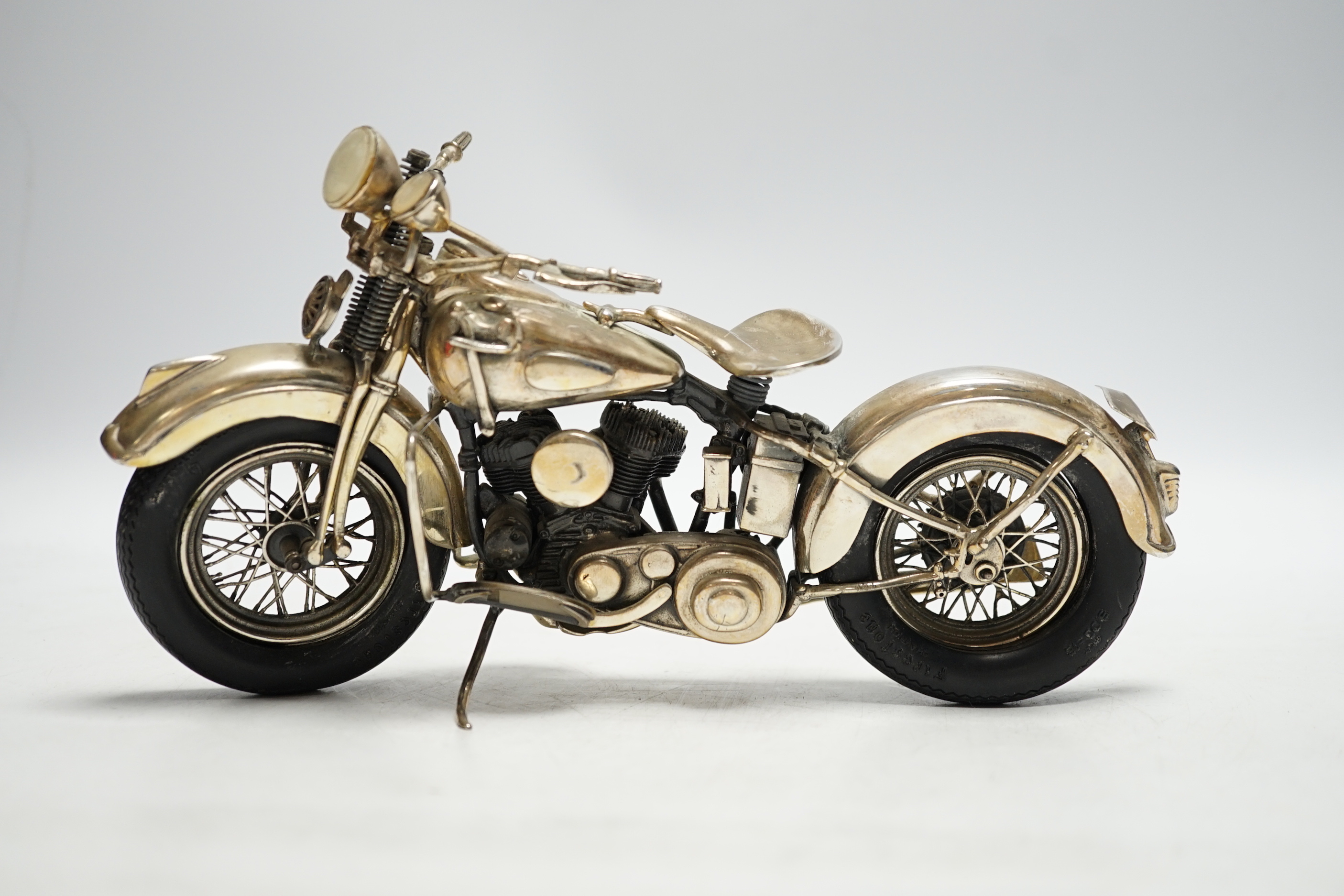 A late 1990's part silver miniature model of a Harley Davidson motor bike, Casa Julia International, London, 1997, length 23.3cm, gross weight 24.9oz.